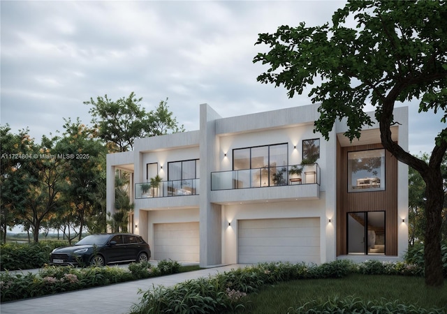 contemporary home with a garage and a balcony