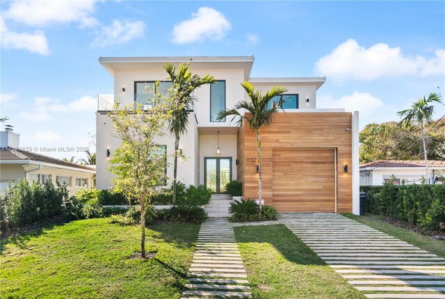 modern home with a garage and a front lawn