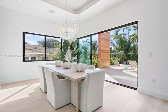 dining space with a chandelier and light wood-type flooring