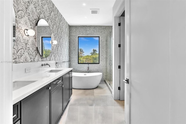 bathroom with vanity, separate shower and tub, and tile walls