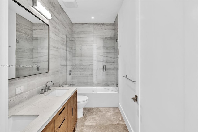 full bathroom featuring shower / bath combination with glass door, vanity, and toilet