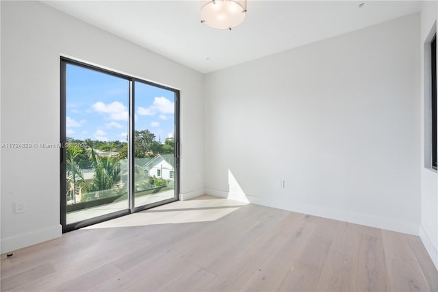 empty room with light hardwood / wood-style flooring