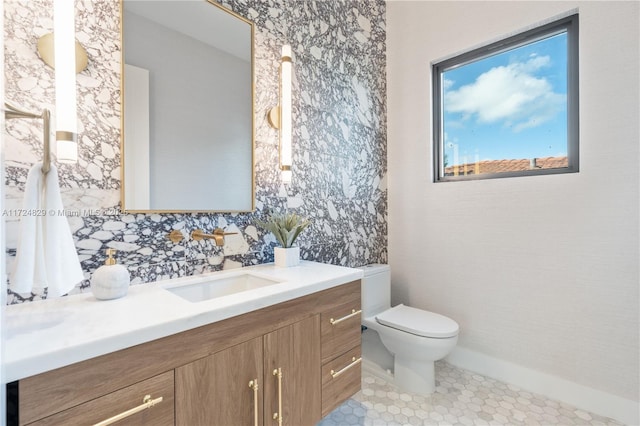 bathroom with vanity, tile patterned flooring, and toilet