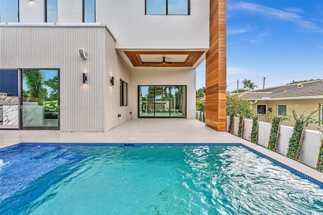 view of pool with ceiling fan and a patio area