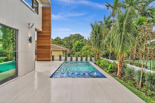 view of swimming pool with a patio