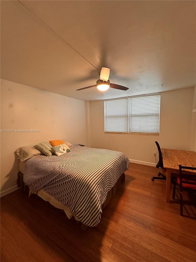 bedroom with hardwood / wood-style flooring and ceiling fan