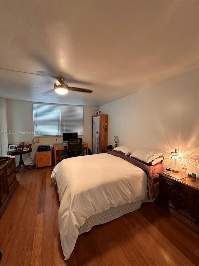 bedroom featuring ceiling fan and dark hardwood / wood-style floors