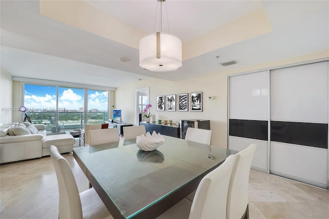 dining room featuring a tray ceiling