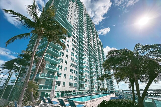 view of building exterior featuring a community pool