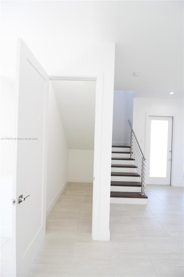 stairway with tile patterned flooring