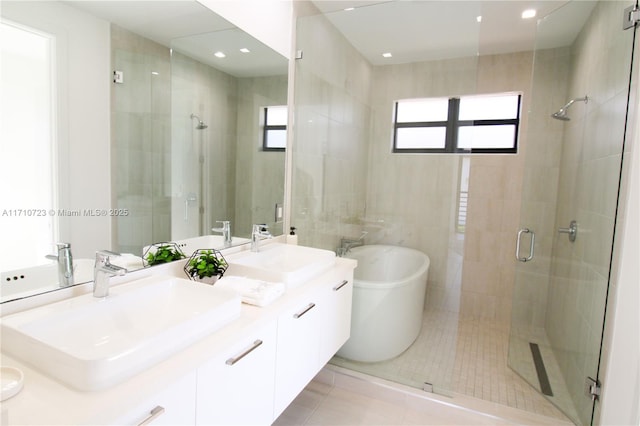 bathroom with tile patterned flooring, vanity, and independent shower and bath