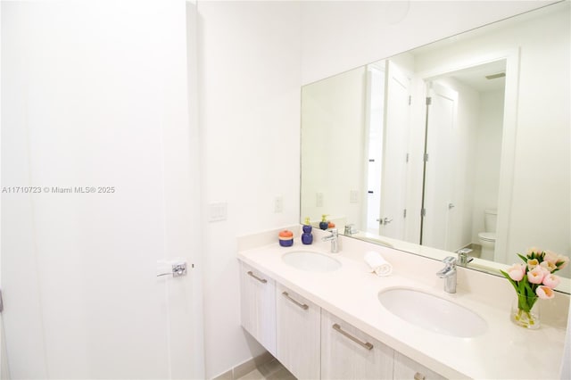 bathroom with vanity and toilet