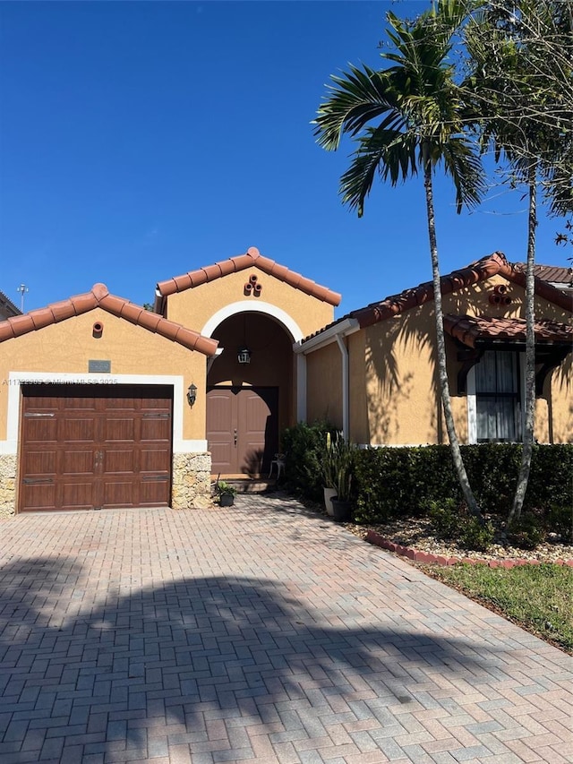 mediterranean / spanish-style home with a garage