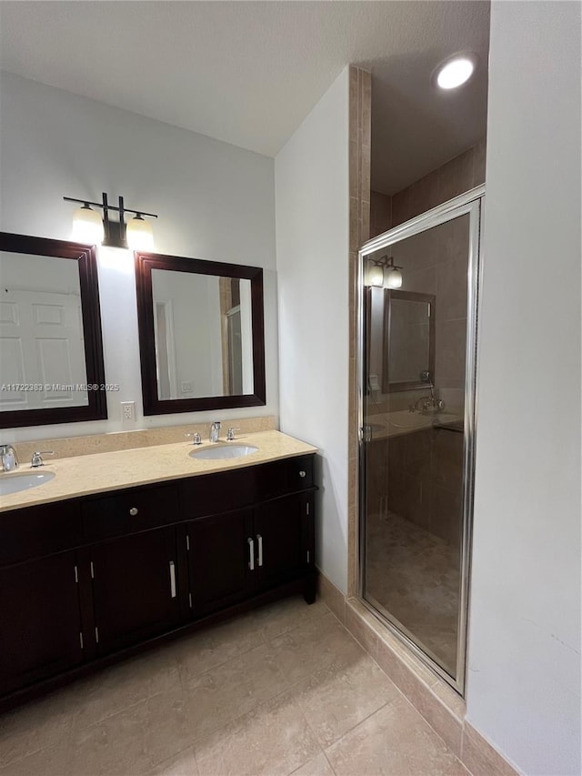 bathroom with vanity, tile patterned floors, and walk in shower