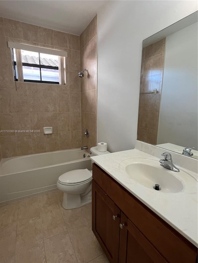 full bathroom with vanity, tile patterned flooring, tiled shower / bath combo, and toilet