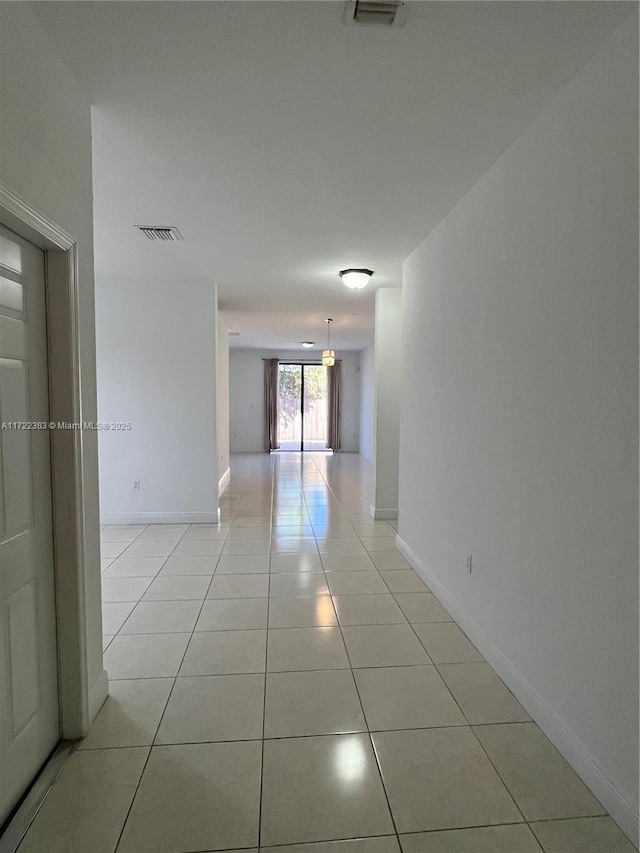 hallway featuring light tile patterned floors