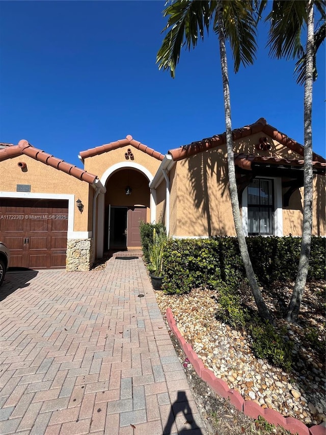 mediterranean / spanish-style house featuring a garage