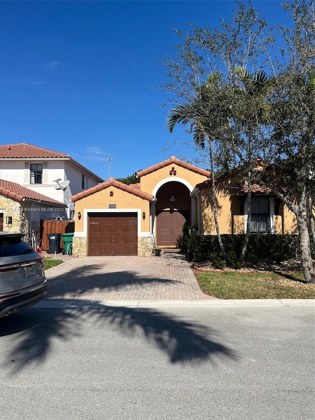 mediterranean / spanish home with a garage