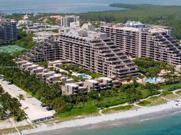 birds eye view of property with a water view and a view of the beach