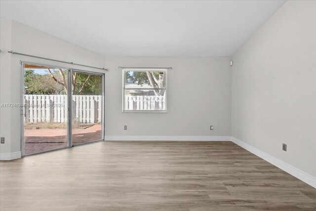 empty room with hardwood / wood-style flooring