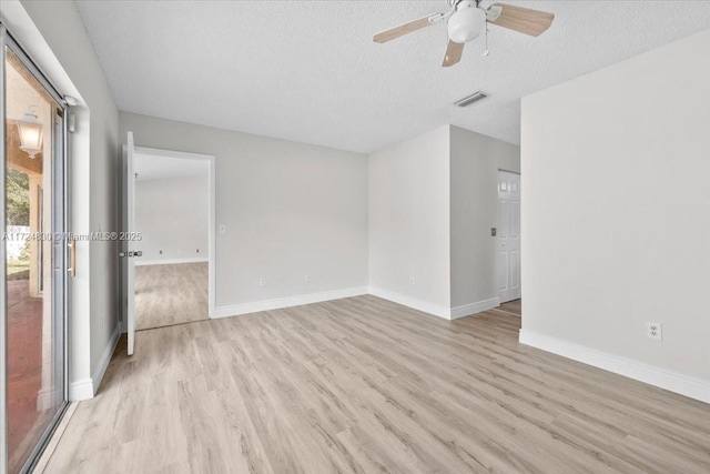 unfurnished room featuring a textured ceiling, light hardwood / wood-style flooring, and ceiling fan