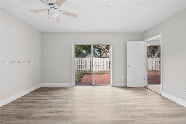 spare room with ceiling fan, light hardwood / wood-style floors, and a textured ceiling