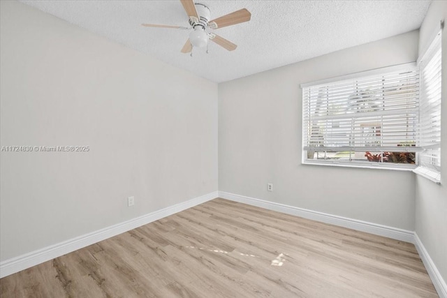 spare room featuring a textured ceiling, light hardwood / wood-style floors, and ceiling fan