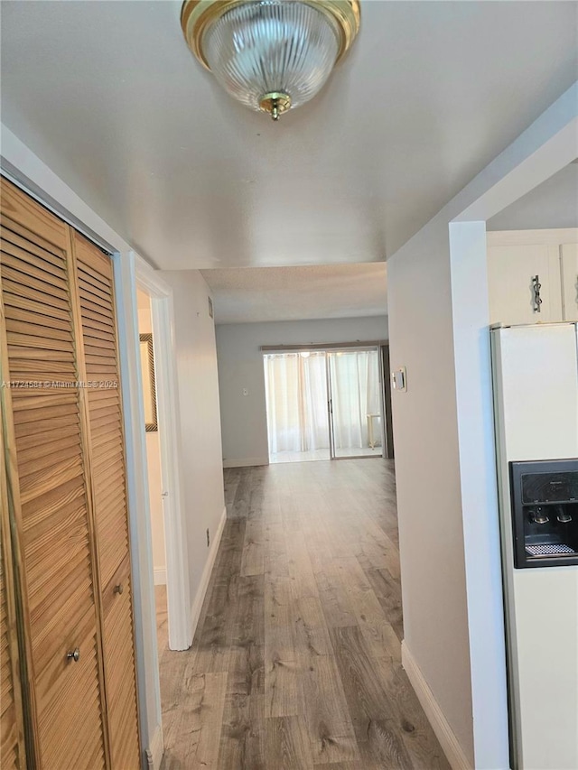 corridor with wood-type flooring