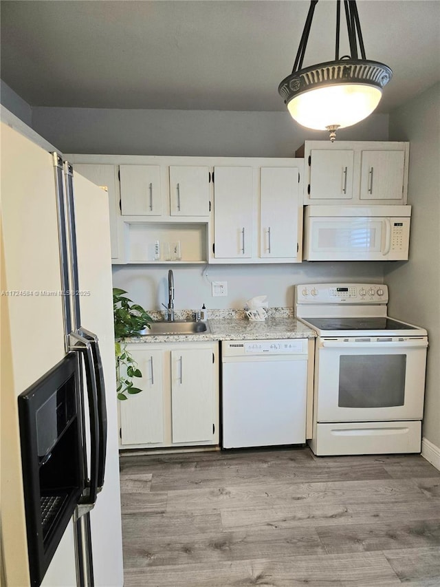 kitchen with white cabinets, pendant lighting, white appliances, and sink