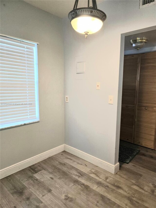 unfurnished room with hardwood / wood-style floors