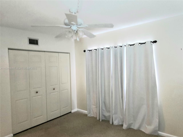 unfurnished bedroom with carpet flooring, ceiling fan, and a closet