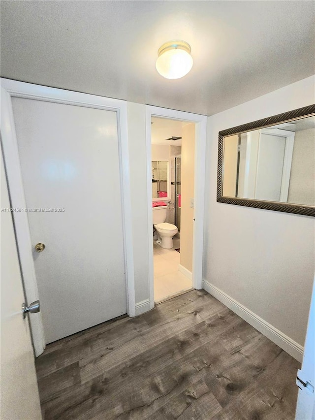 hallway with dark wood-type flooring