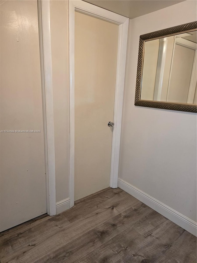 hallway featuring wood-type flooring