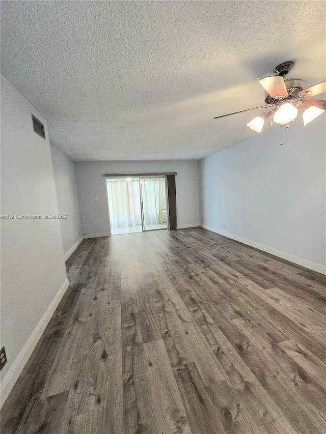 empty room with a textured ceiling, hardwood / wood-style flooring, and ceiling fan