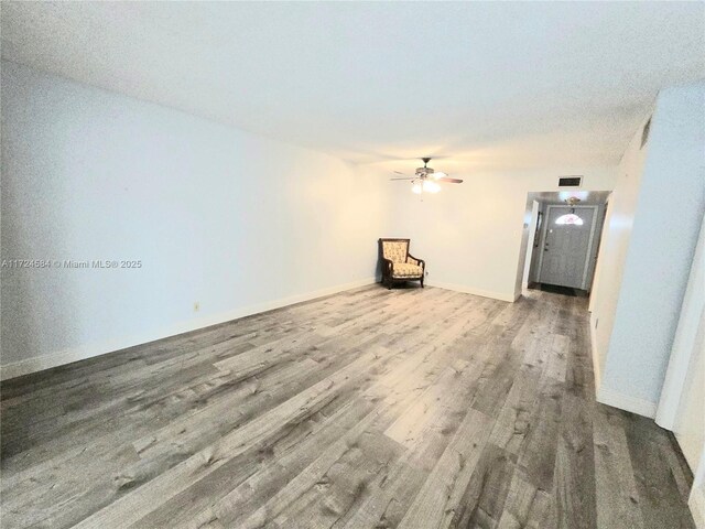 unfurnished room featuring ceiling fan, light hardwood / wood-style flooring, and a textured ceiling