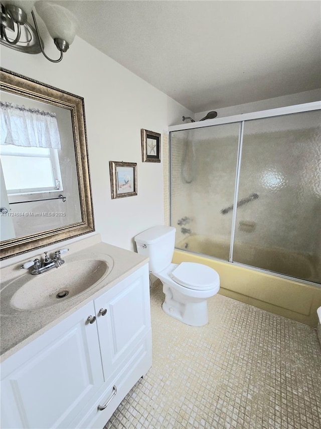 full bathroom with shower / bath combination with glass door, vanity, and toilet