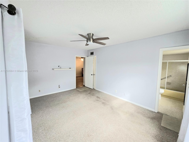 unfurnished bedroom featuring ceiling fan, carpet floors, and connected bathroom