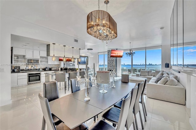 tiled dining room with a notable chandelier