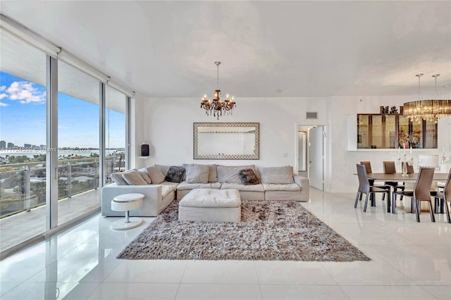 tiled living room with a city view, expansive windows, visible vents, and a notable chandelier