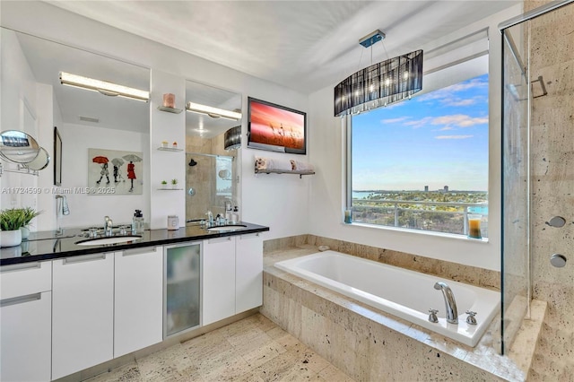 full bath featuring a bath, a sink, double vanity, and a stall shower