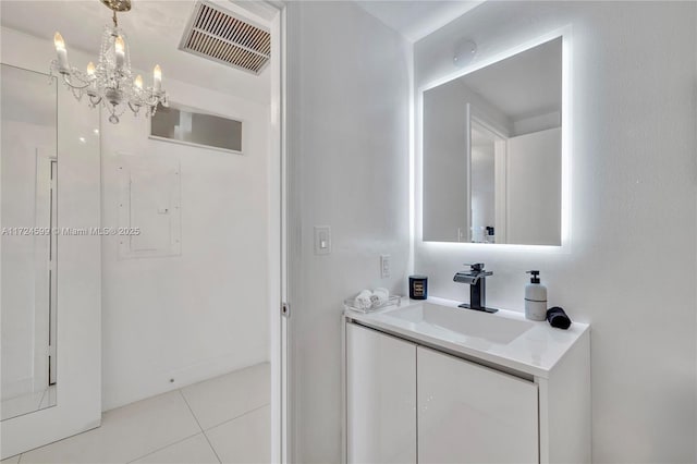 bathroom with a chandelier, visible vents, tile patterned floors, and vanity
