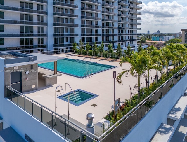 community pool featuring a city view and a patio