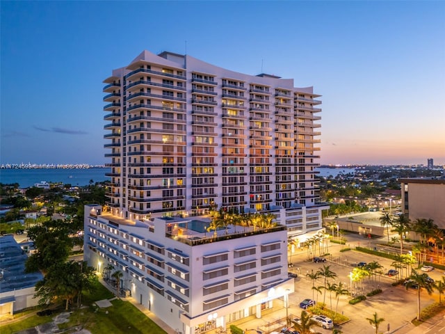property at dusk featuring a water view