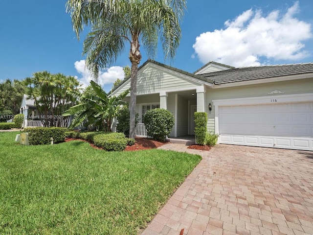 view of front of property with a garage and a front lawn