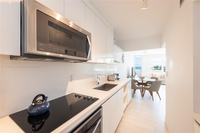 kitchen featuring sink, white cabinets, and appliances with stainless steel finishes