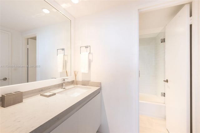 bathroom with shower / bath combination with glass door, vanity, and tile patterned flooring