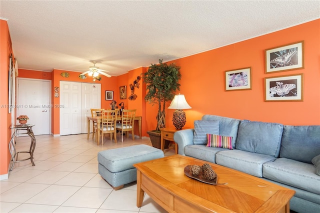 tiled living room with a textured ceiling and ceiling fan