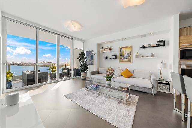 living room featuring a water view and expansive windows