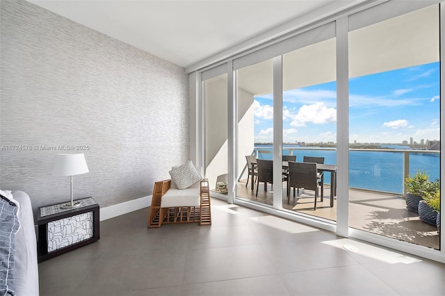 sitting room with expansive windows and a water view