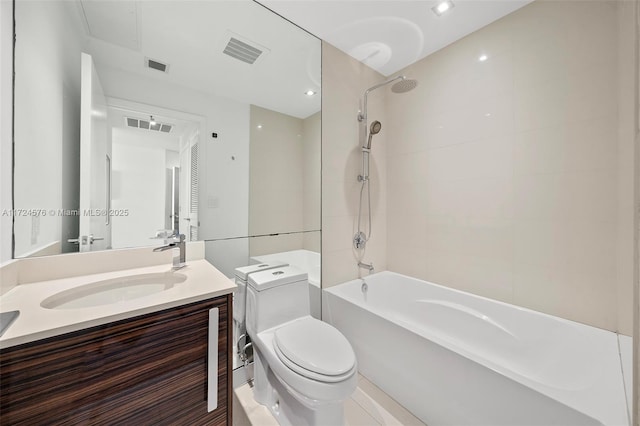 full bathroom featuring toilet, vanity, and tiled shower / bath